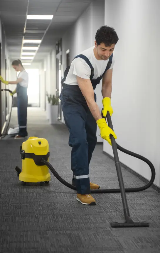 Janitorial staff vacuuming commercial corridor in Calgary